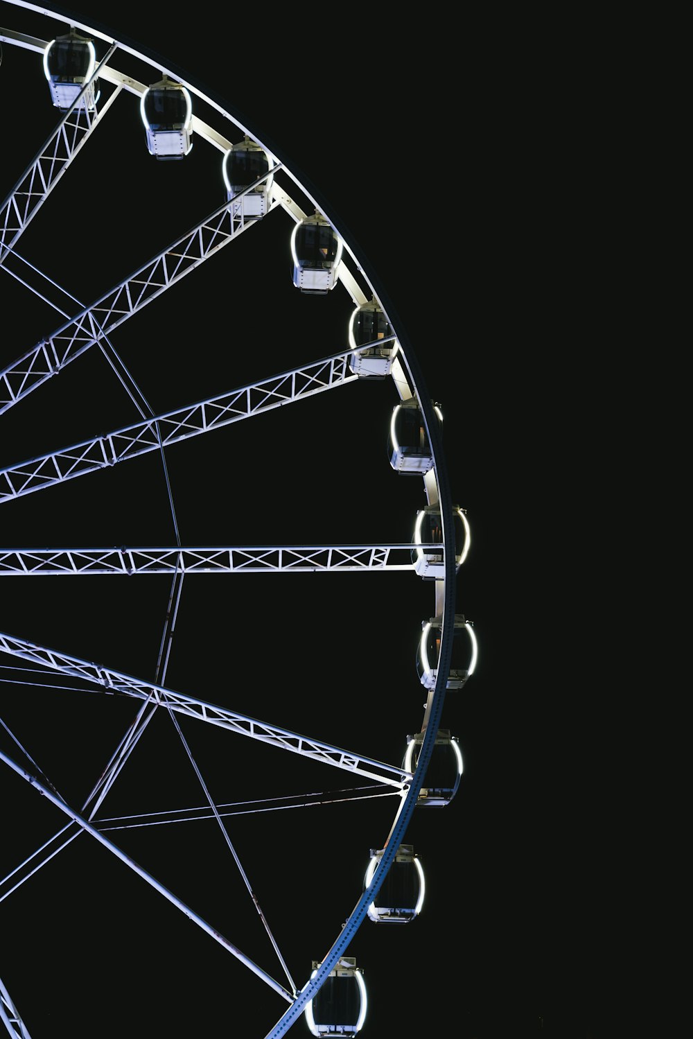 a ferris wheel lit up against a black background