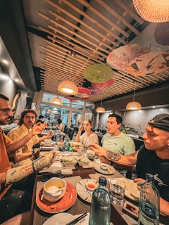 a group of people sitting around a table eating food