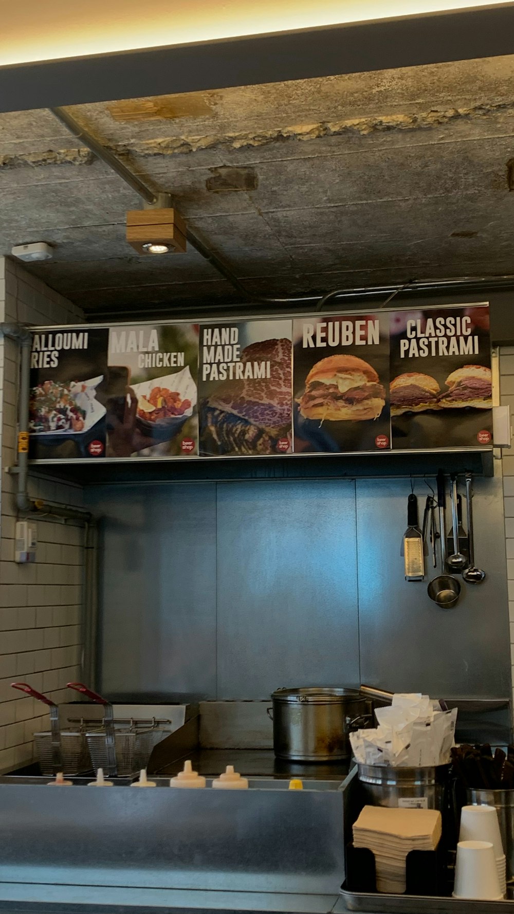 a restaurant kitchen with menus on the wall