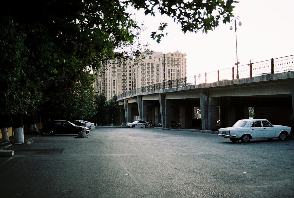 a car parked in a parking lot next to a bridge