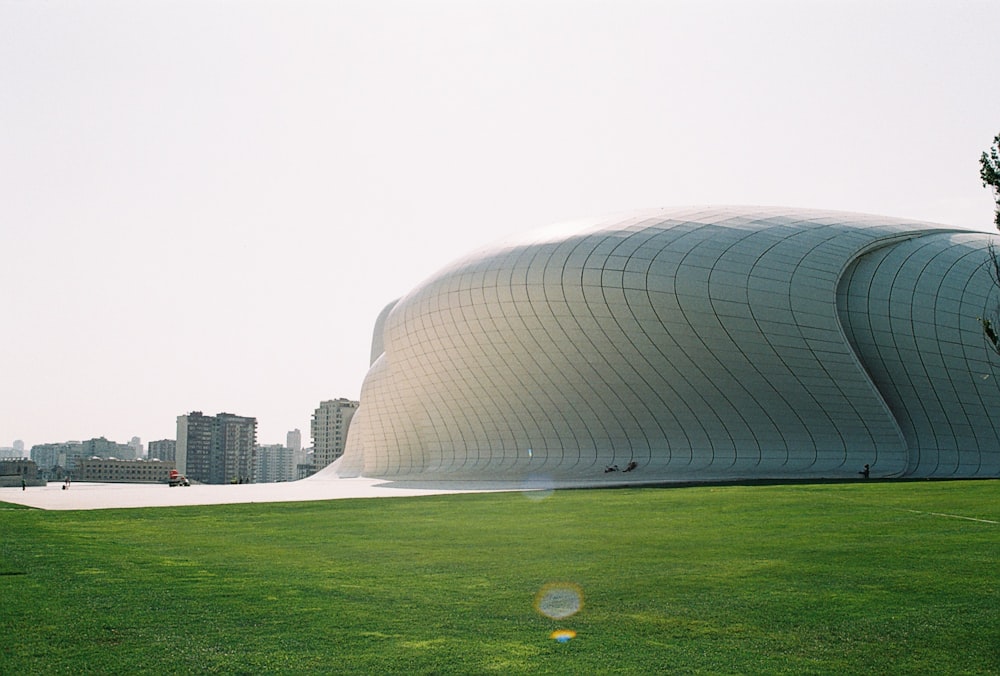 a large building sitting on top of a lush green field