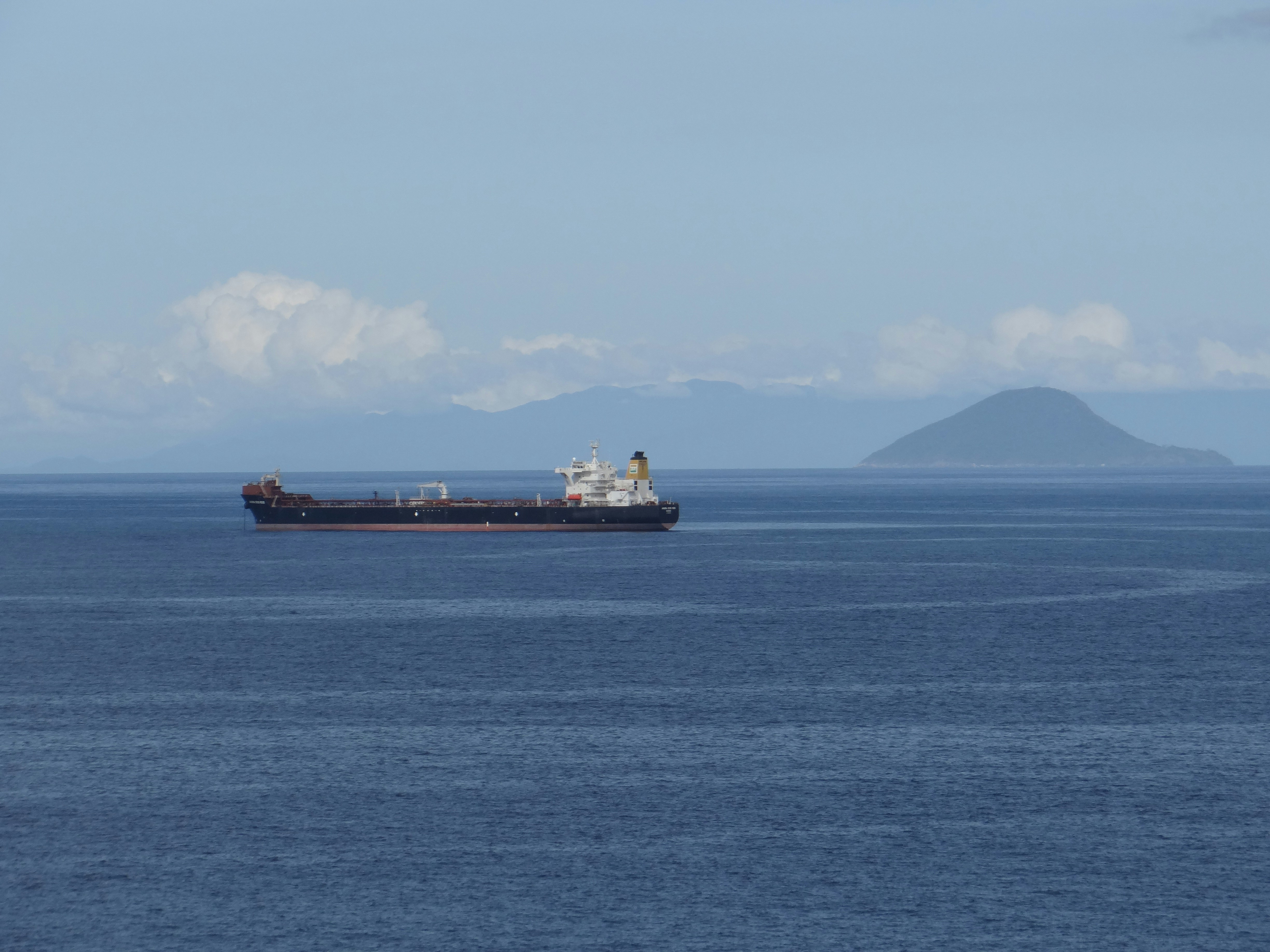 海の真ん中に浮かぶ大型貨物船