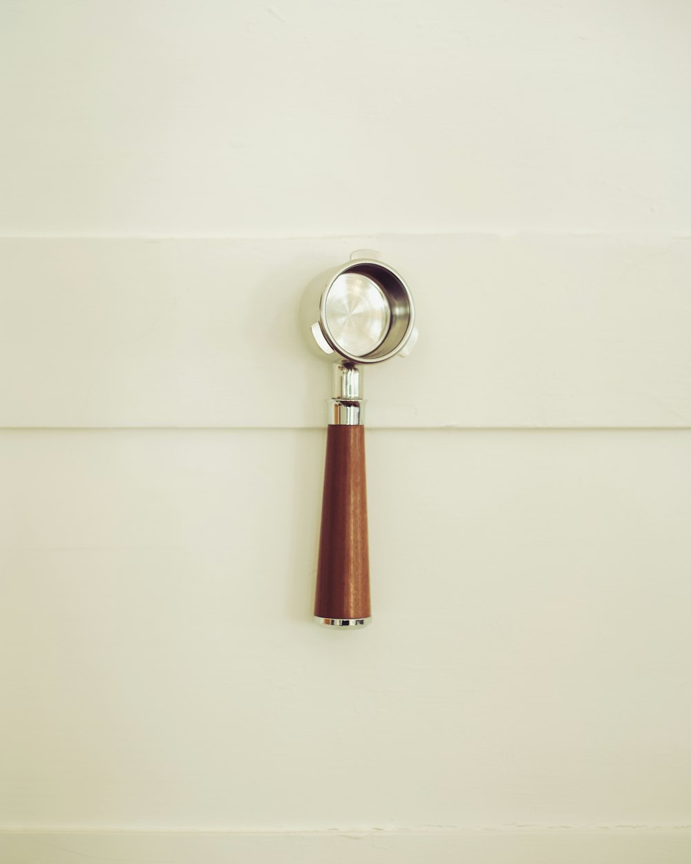 a magnifying glass sitting on top of a wooden handle