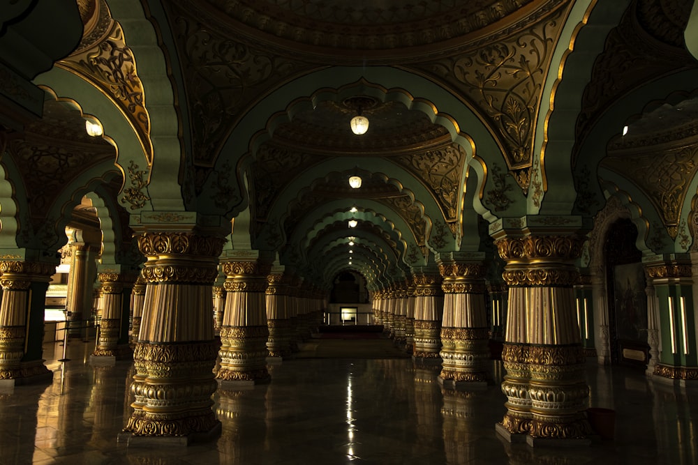 a large room with columns and a clock on the wall