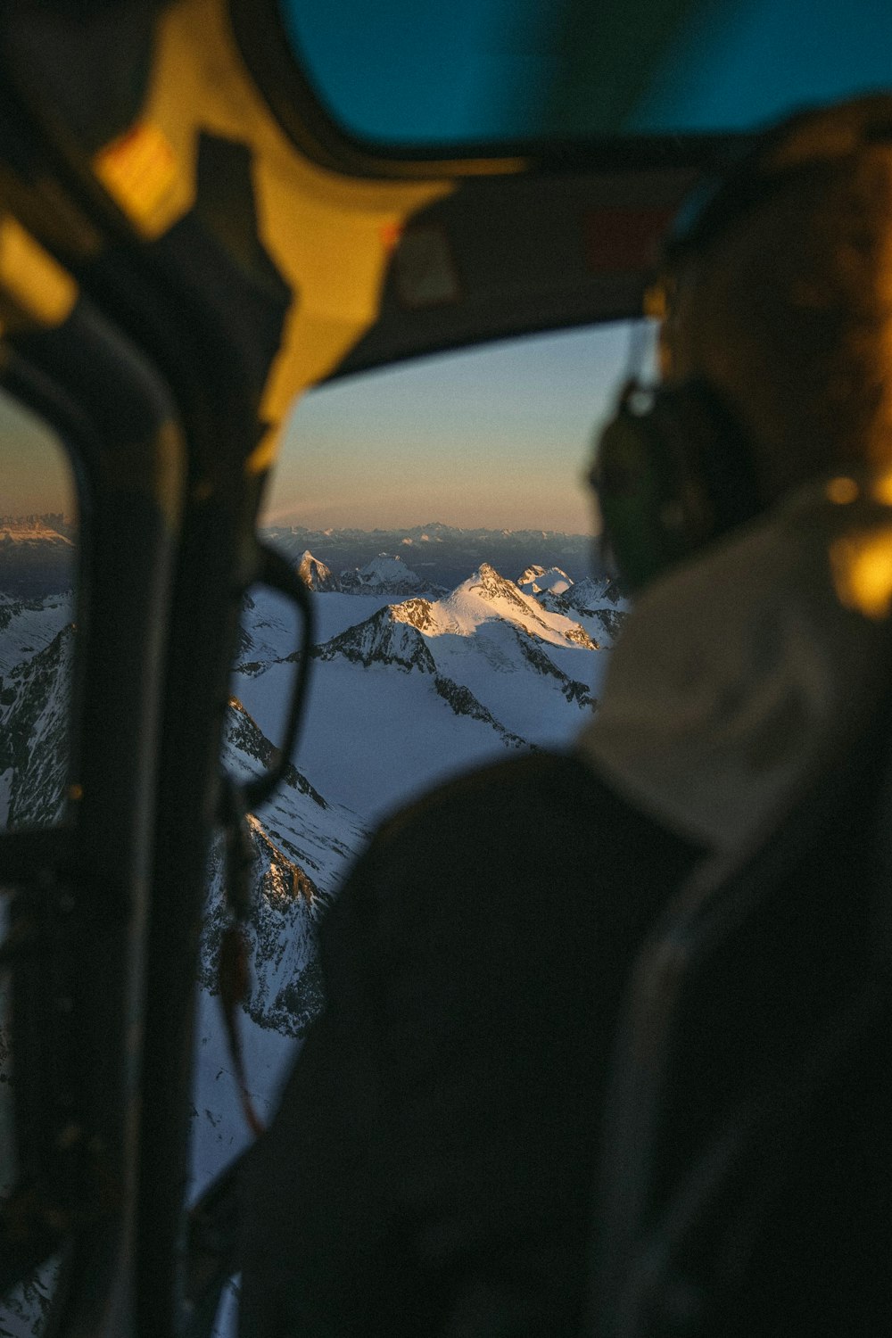 a man sitting in the cockpit of a plane looking out the window