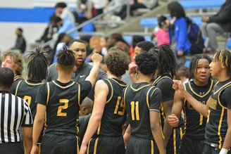 a group of young men standing next to each other on a basketball court