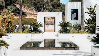 a white house with a glass table in front of it