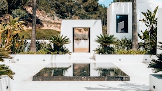 a white house with a glass table in front of it