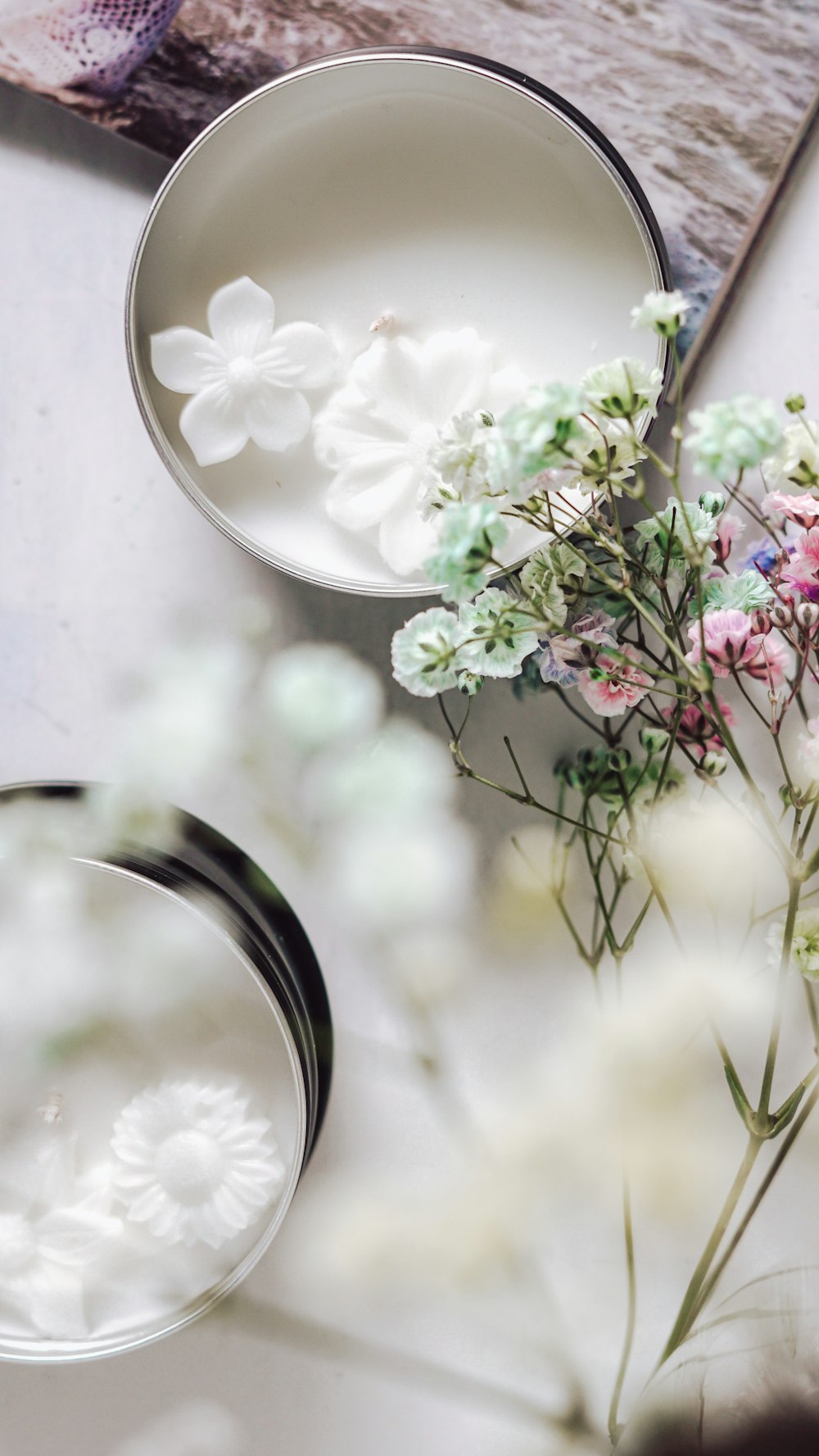 a close up of a vase with flowers on a table