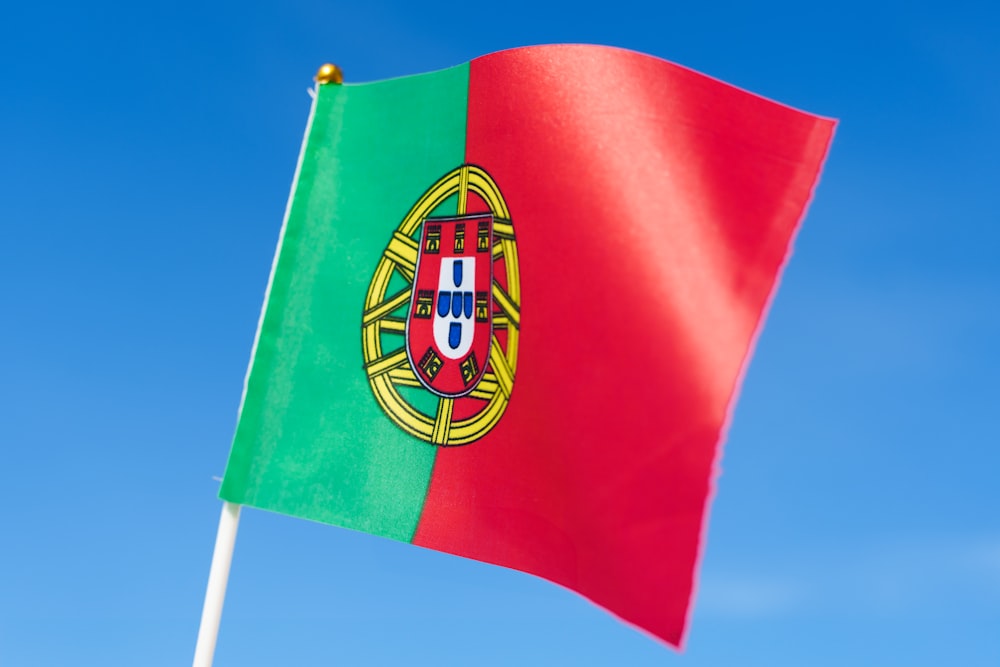 the flag of portugal is waving in the wind