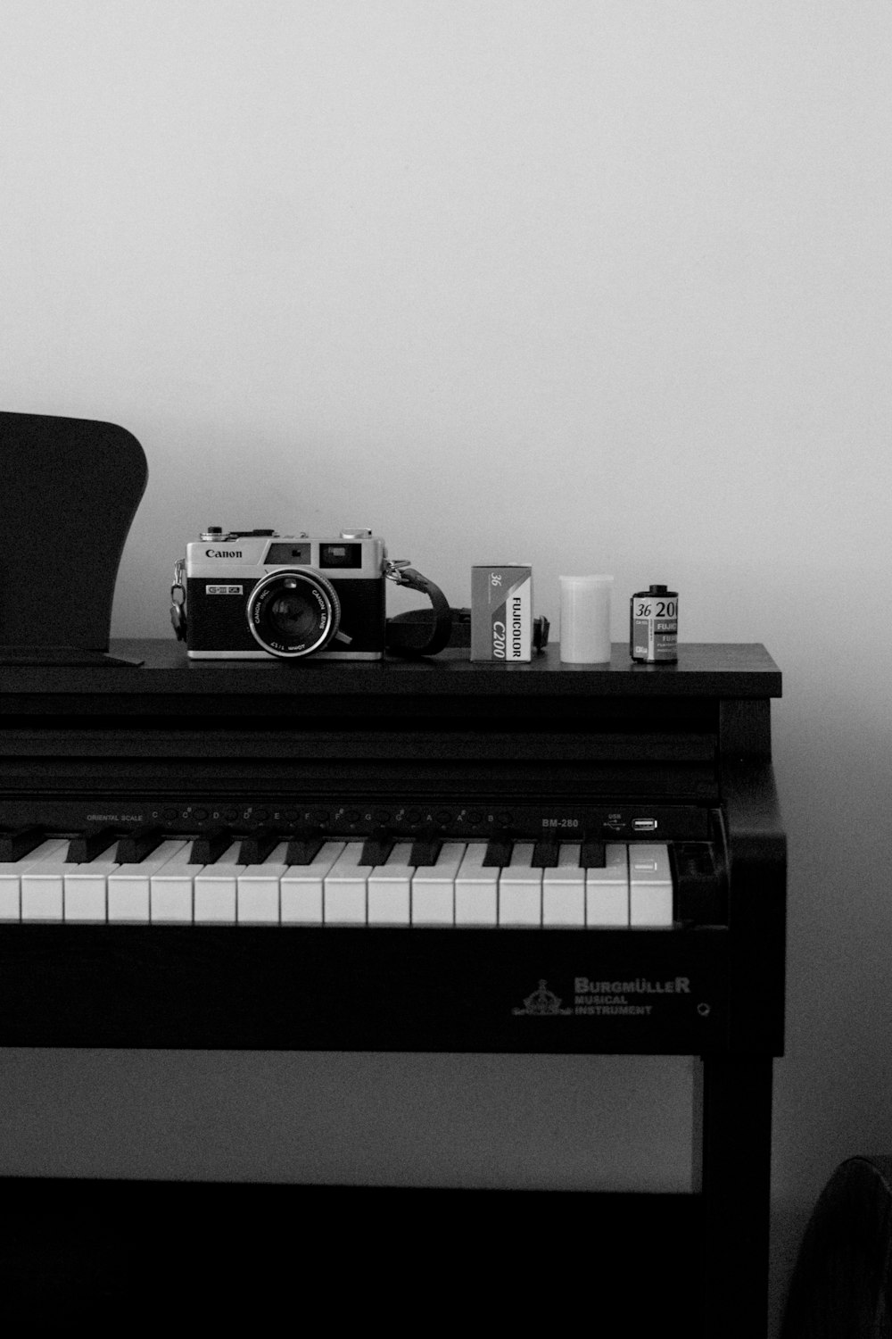 a black and white photo of a piano and a camera
