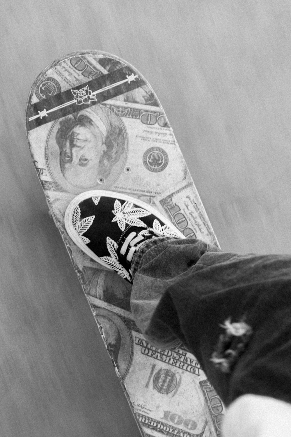 a person is standing on a skateboard with money on it