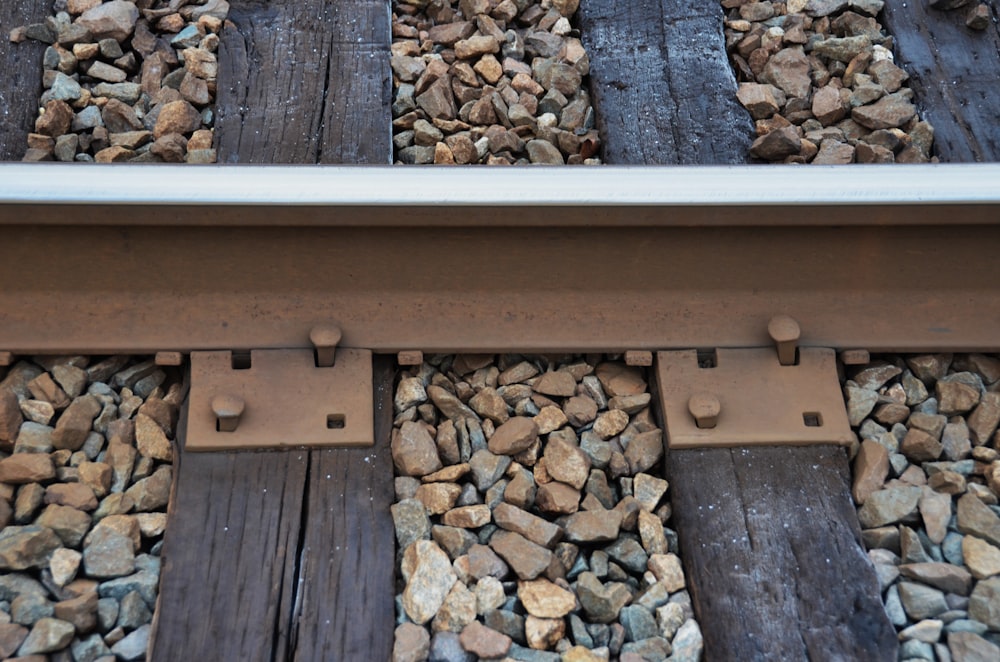 a close up of a train track with rocks on it