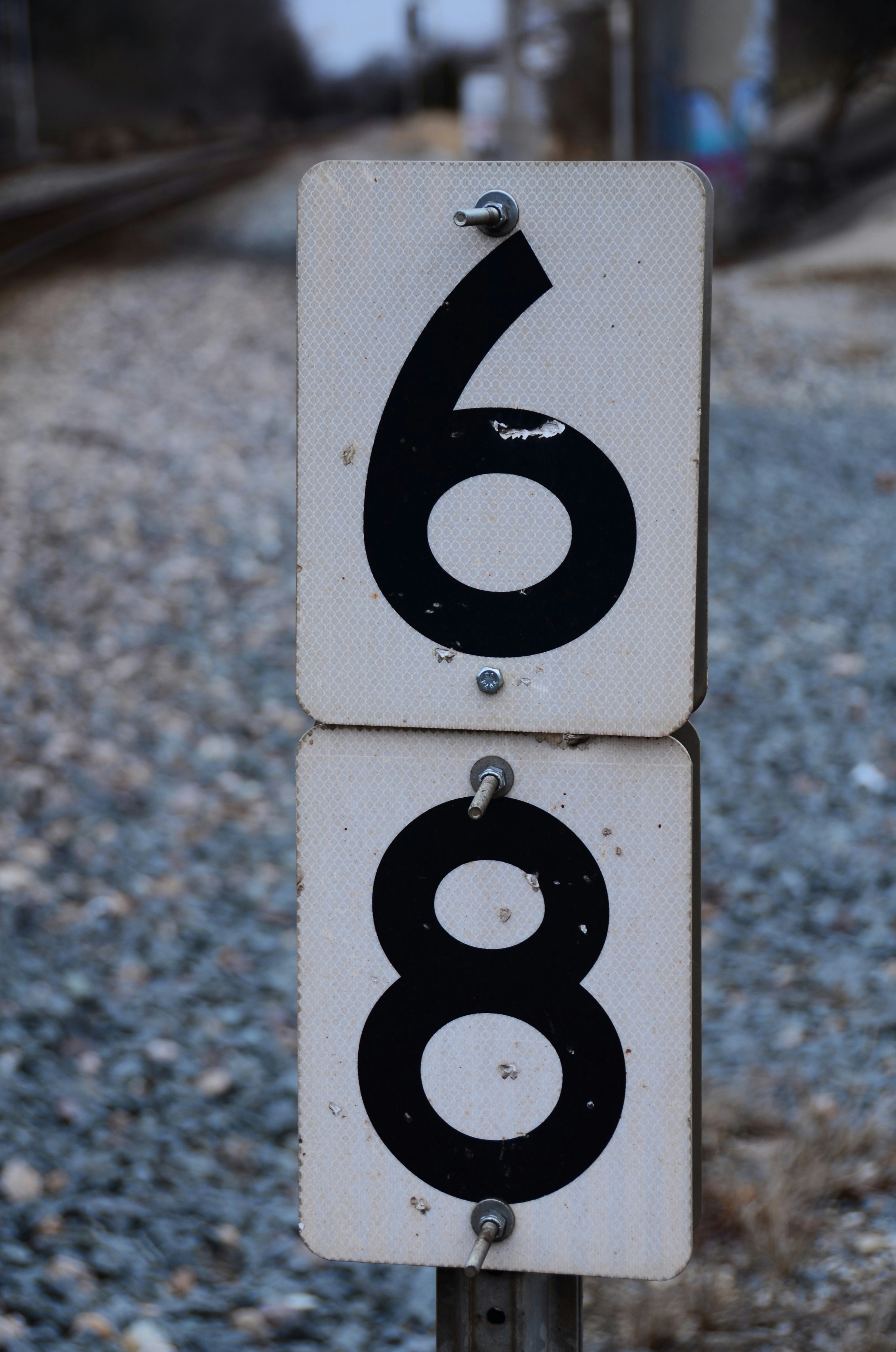 7 Signs You’re Overtraining (And What to Do Instead) – a close up of a street sign with a train track in the background
