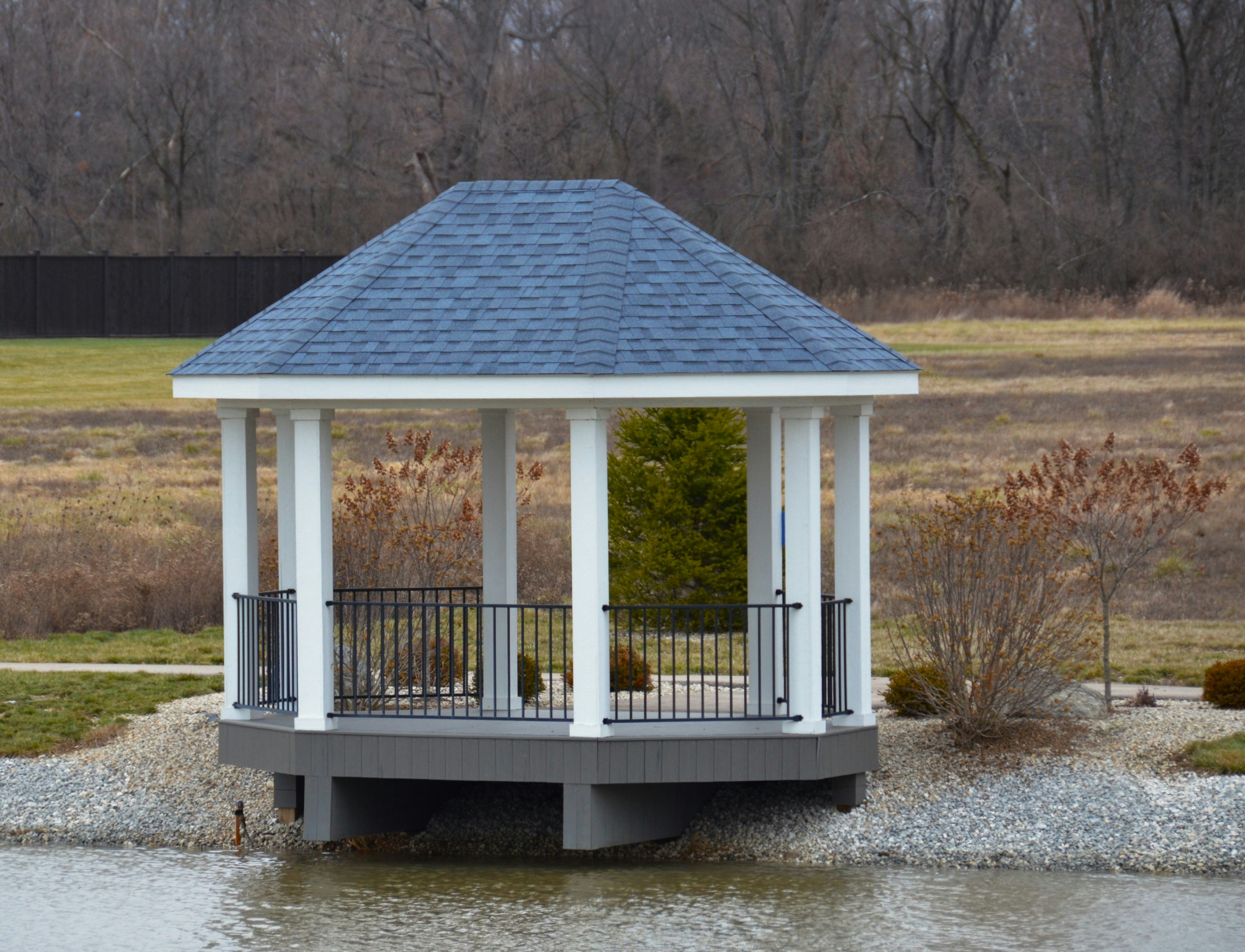 a small white gazebo with a blue roof