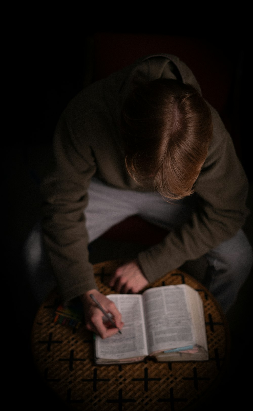 a person sitting on a chair reading a book