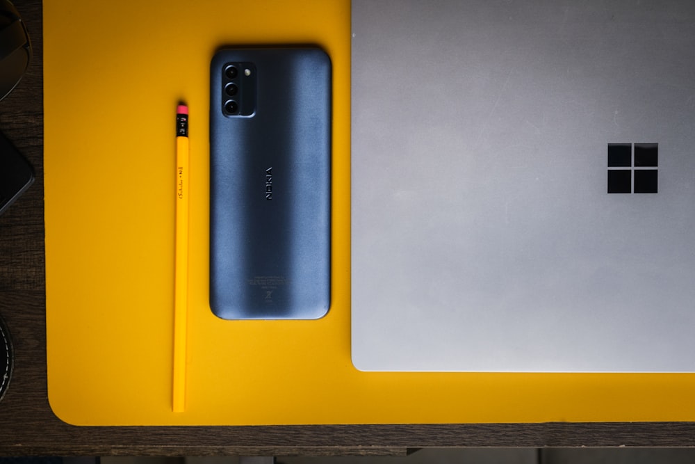 a laptop computer sitting on top of a yellow table