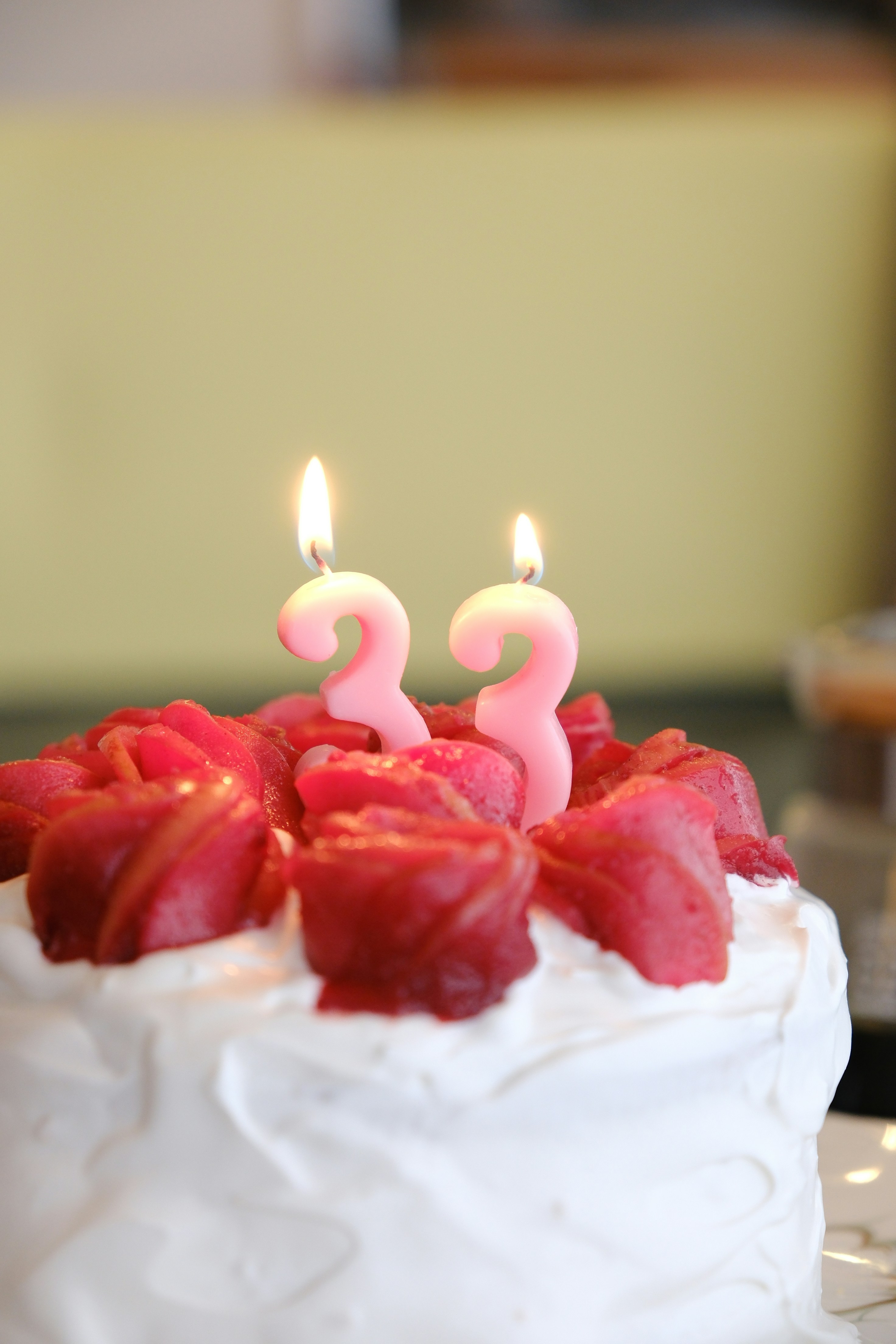 a white cake with pink candles on top of it