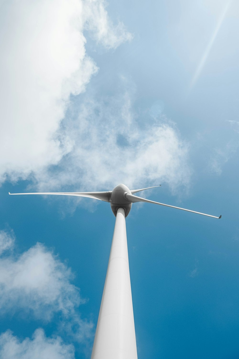 a wind turbine with a blue sky in the background