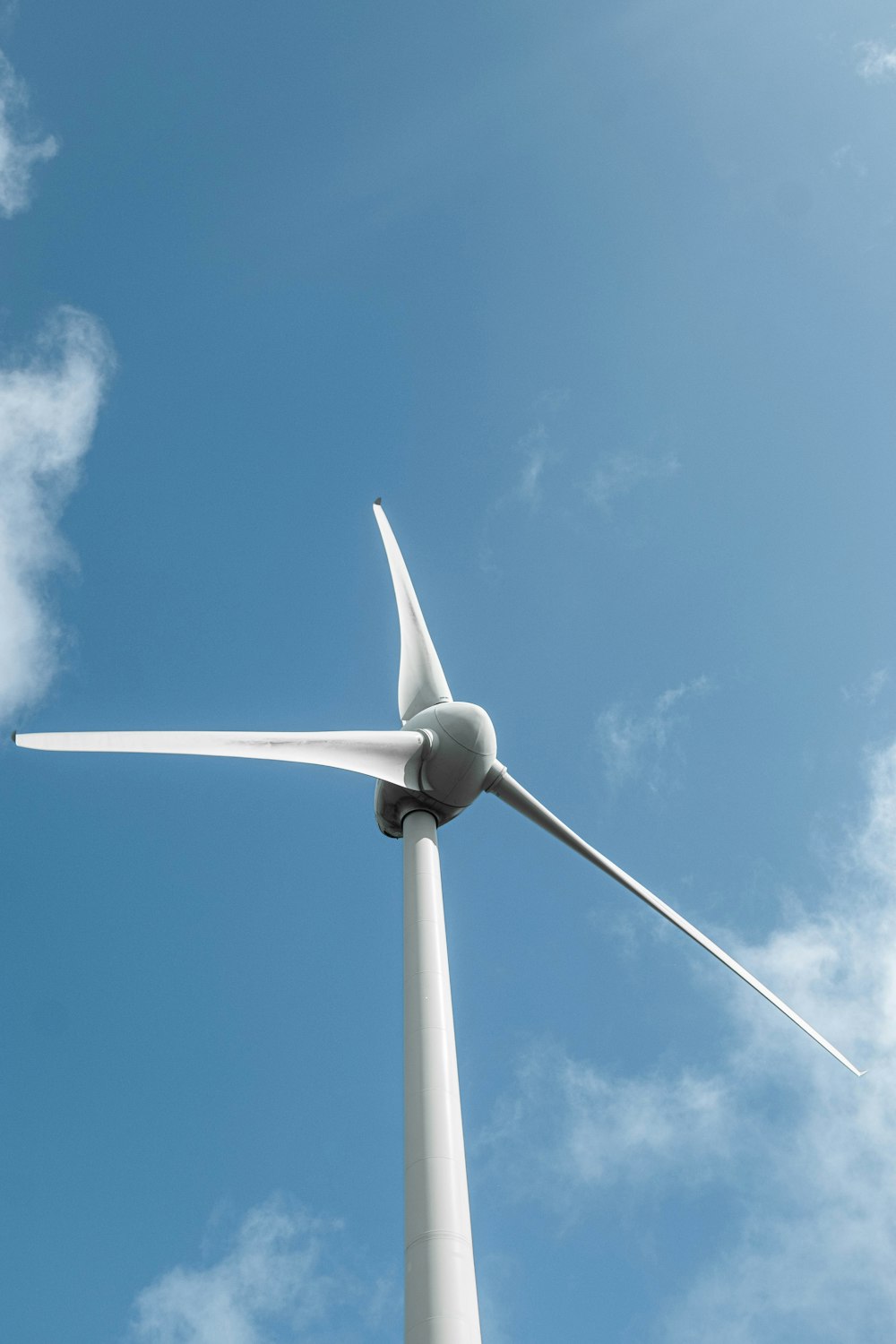 a wind turbine is shown against a blue sky