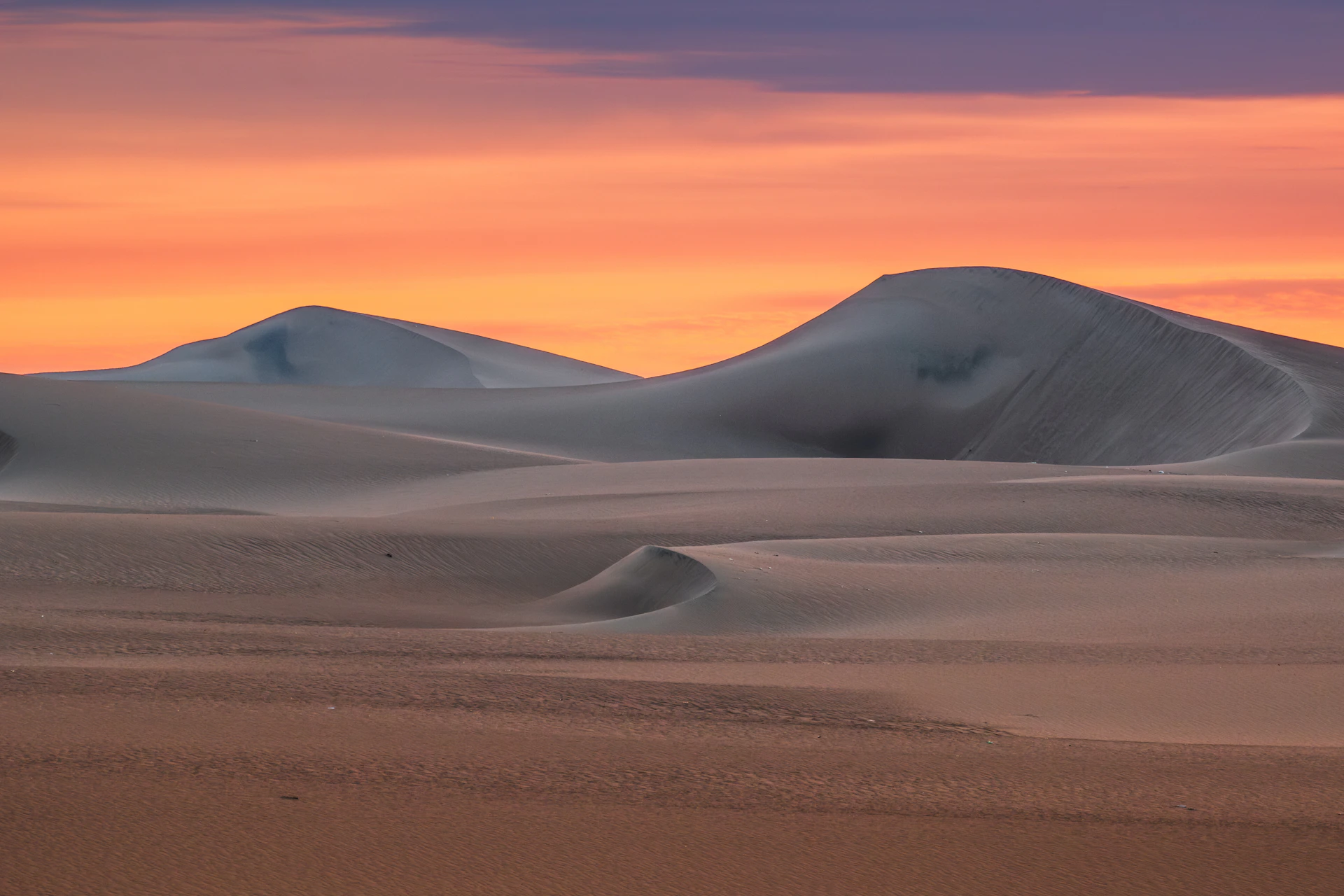 A desert landscape with mountains in the distance