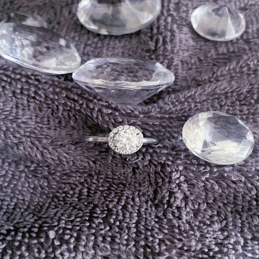 a close up of a diamond ring on a blanket