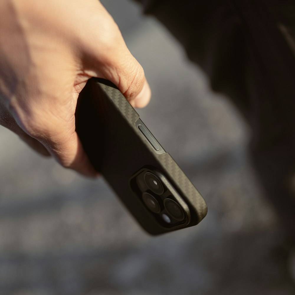 a person holding a remote control in their hand