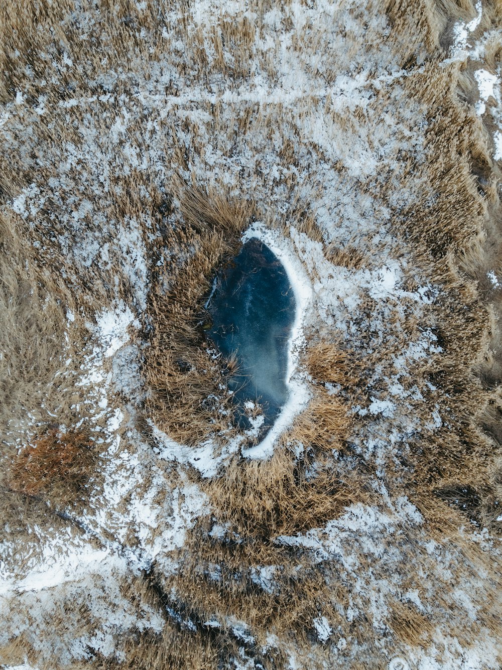 an aerial view of a snow covered field