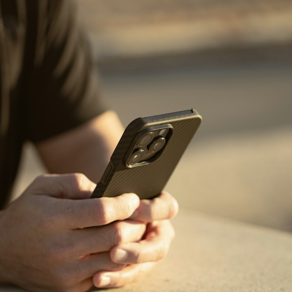 a close up of a person holding a cell phone