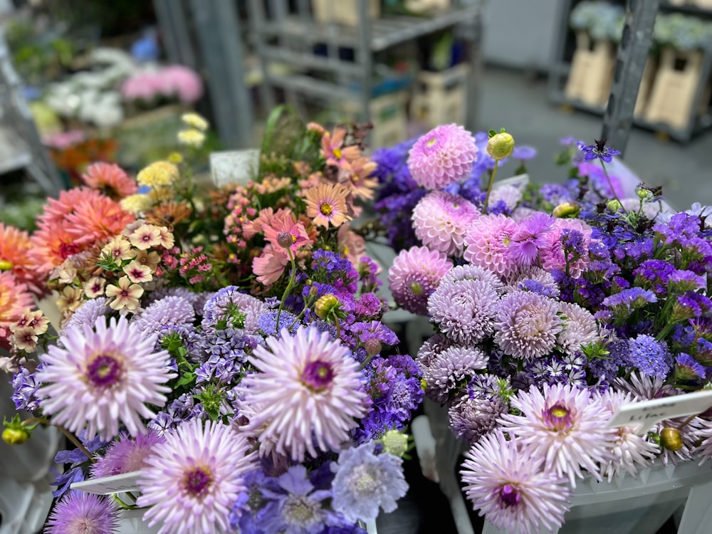 a bunch of flowers that are sitting in a basket