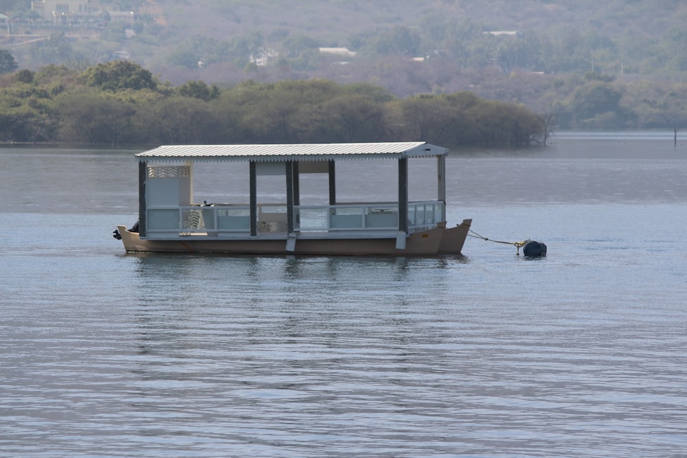 a small boat floating on top of a lake