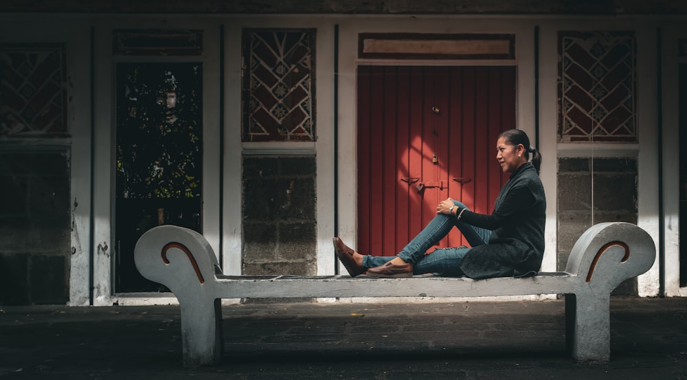 a man sitting on a bench in front of a building