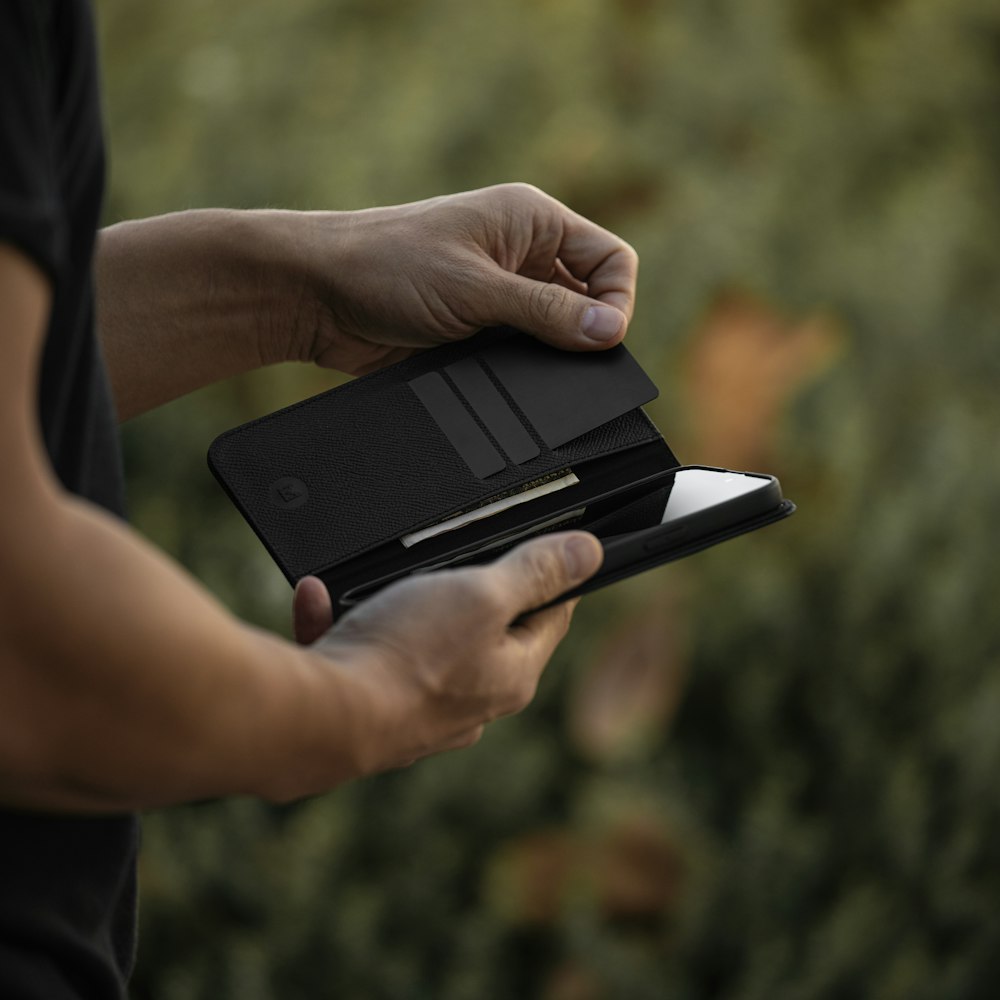 a person holding a wallet in their hand