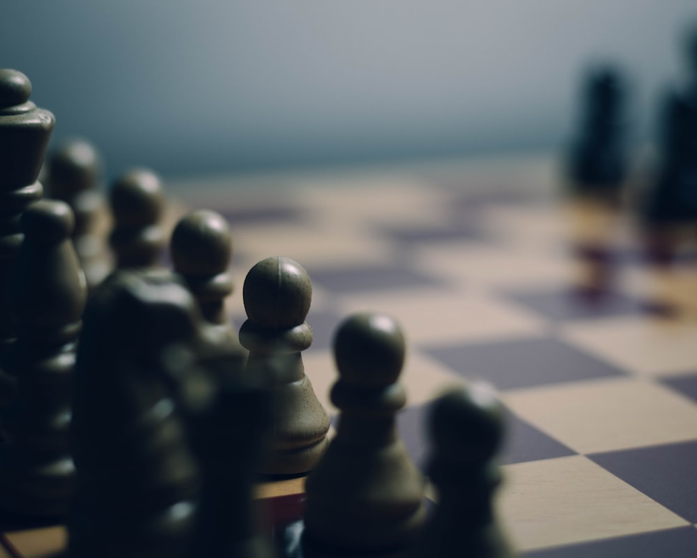 a close up of a chess board with pieces on it