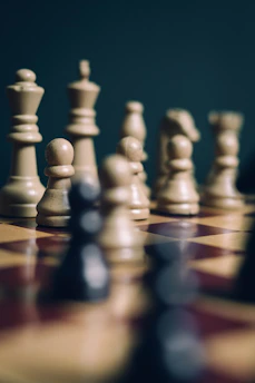 a group of chess pieces sitting on top of a chess board