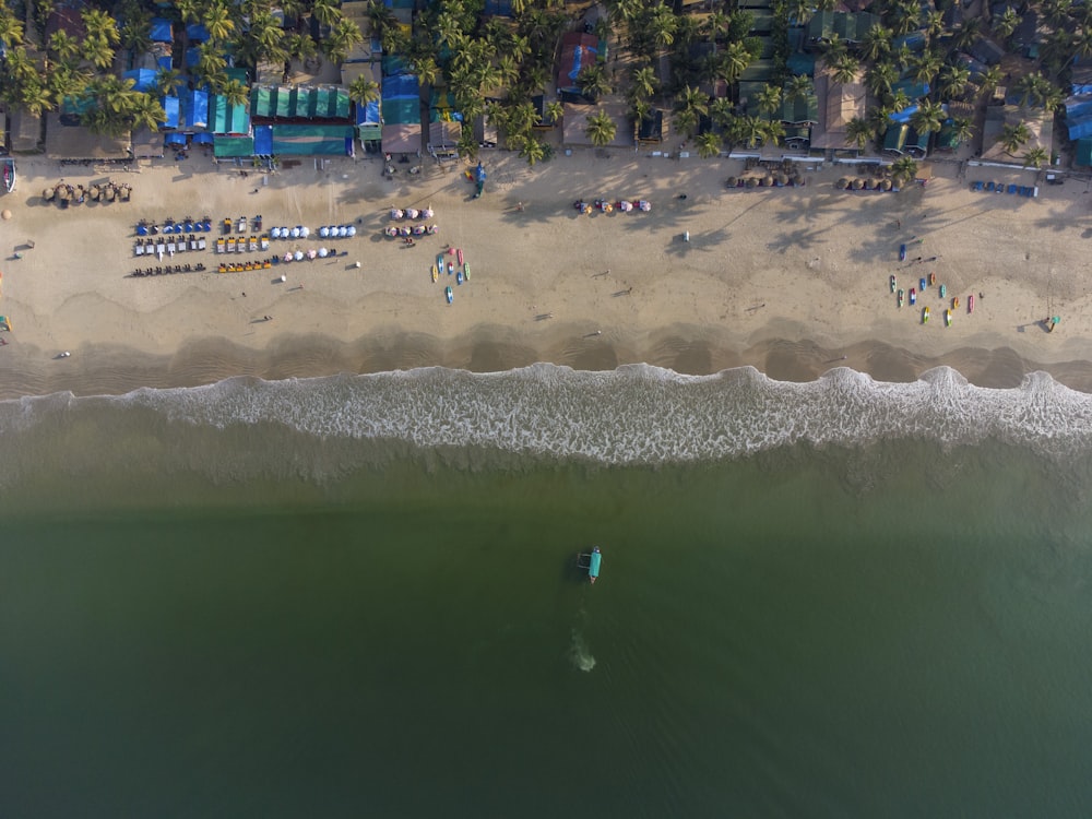 an aerial view of a beach with a surfboard in the water