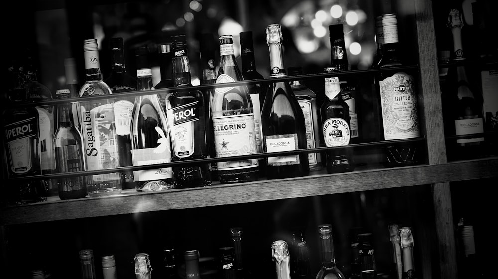 a shelf filled with lots of bottles of alcohol