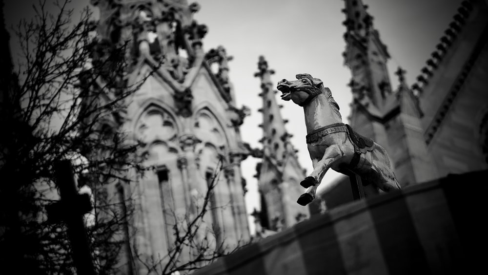 a black and white photo of a statue of a horse