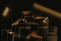 a black and gold abstract painting of cubes