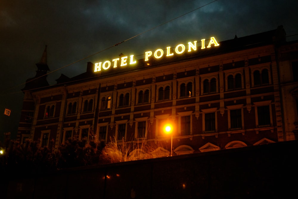 a hotel is lit up at night in the dark