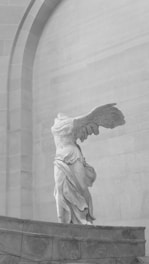 a black and white photo of an angel statue