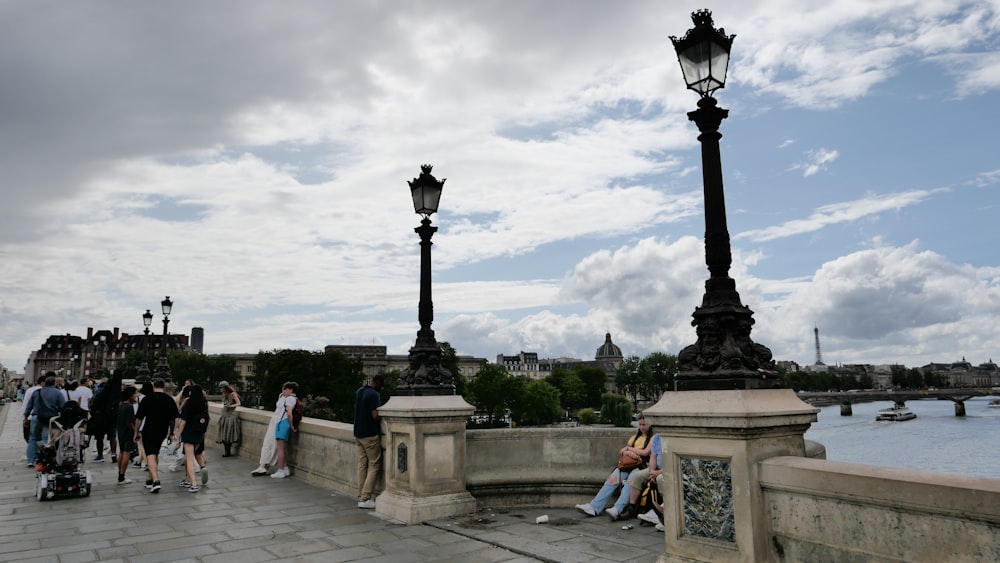 a group of people walking across a bridge