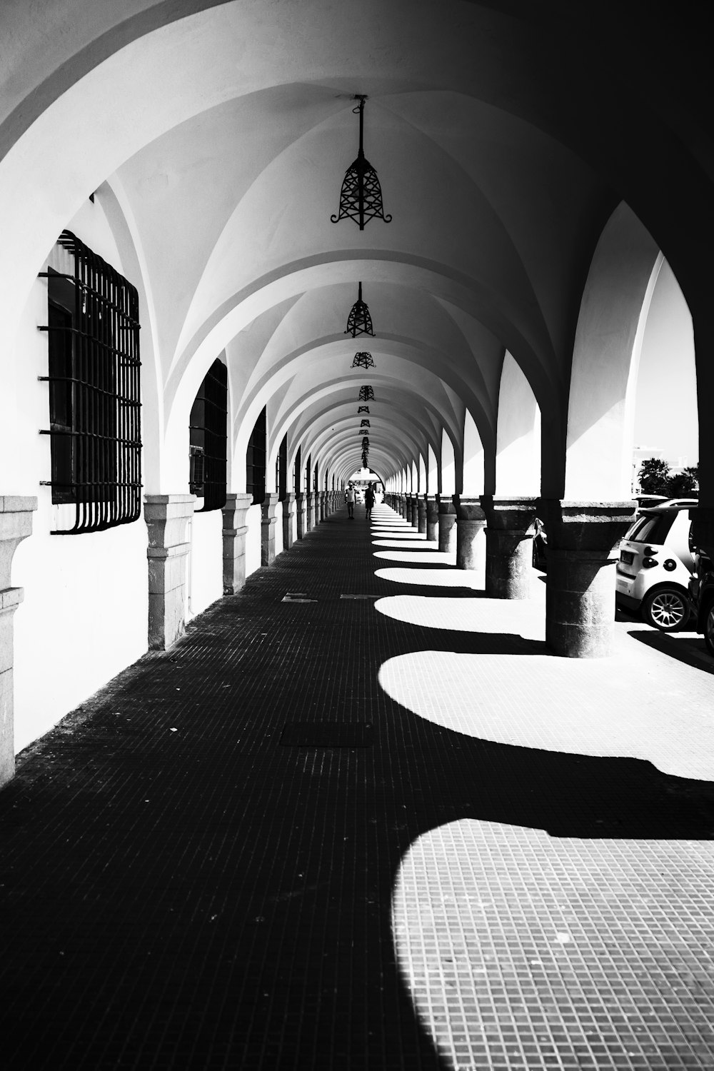 a black and white photo of a long hallway