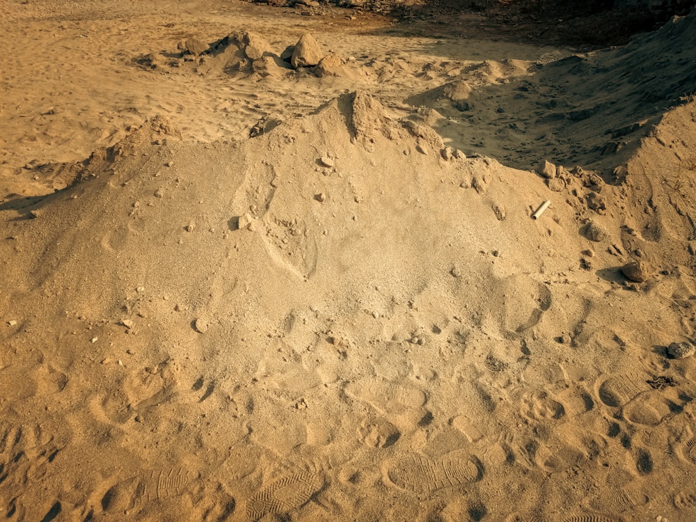 a pile of sand sitting on top of a sandy beach