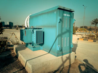 a large blue box sitting on the side of a road