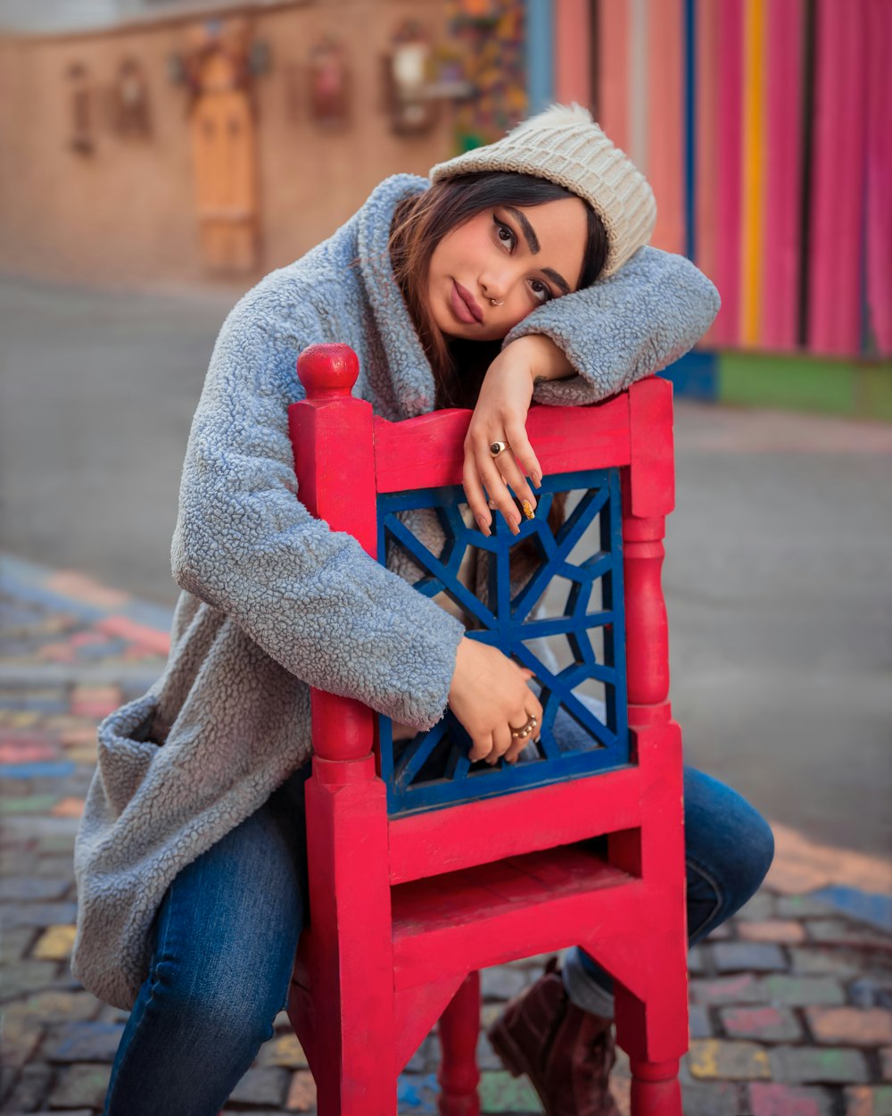 a woman sitting on top of a red chair