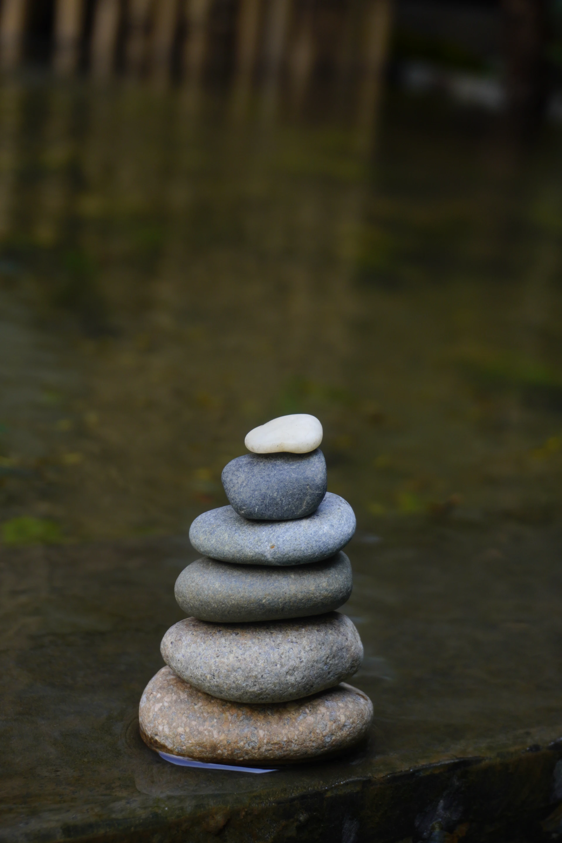 a stack of rocks sitting on top of a body of water