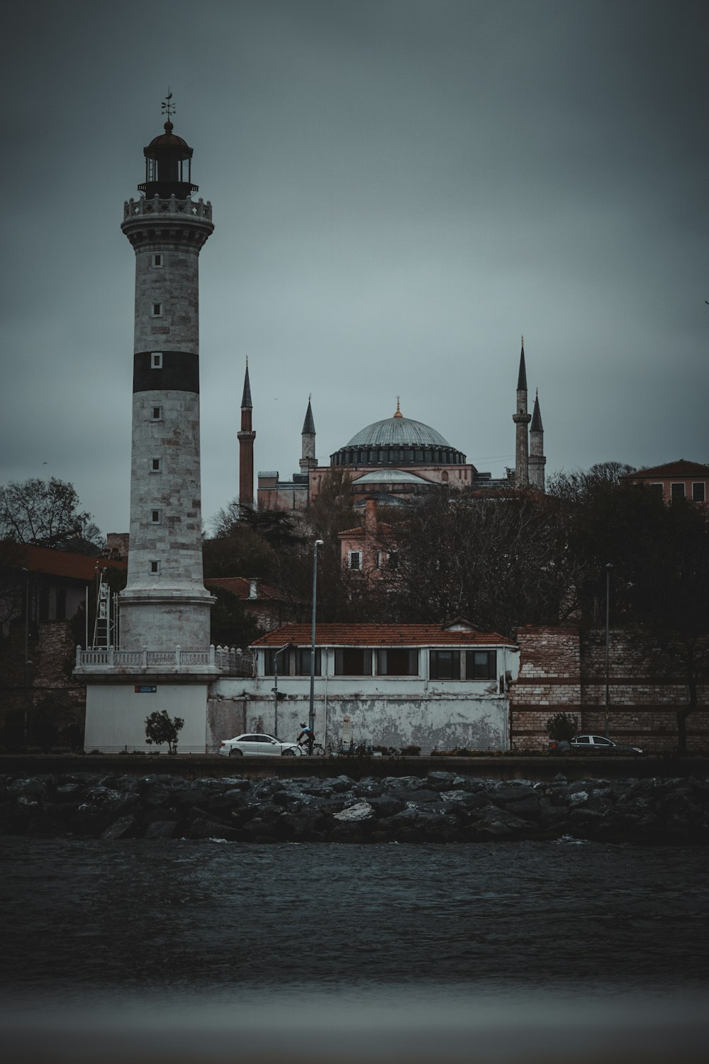 a light house sitting next to a body of water