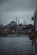 a large body of water with a city in the background