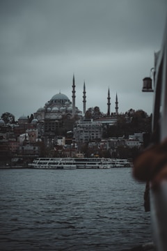 a large body of water with a city in the background
